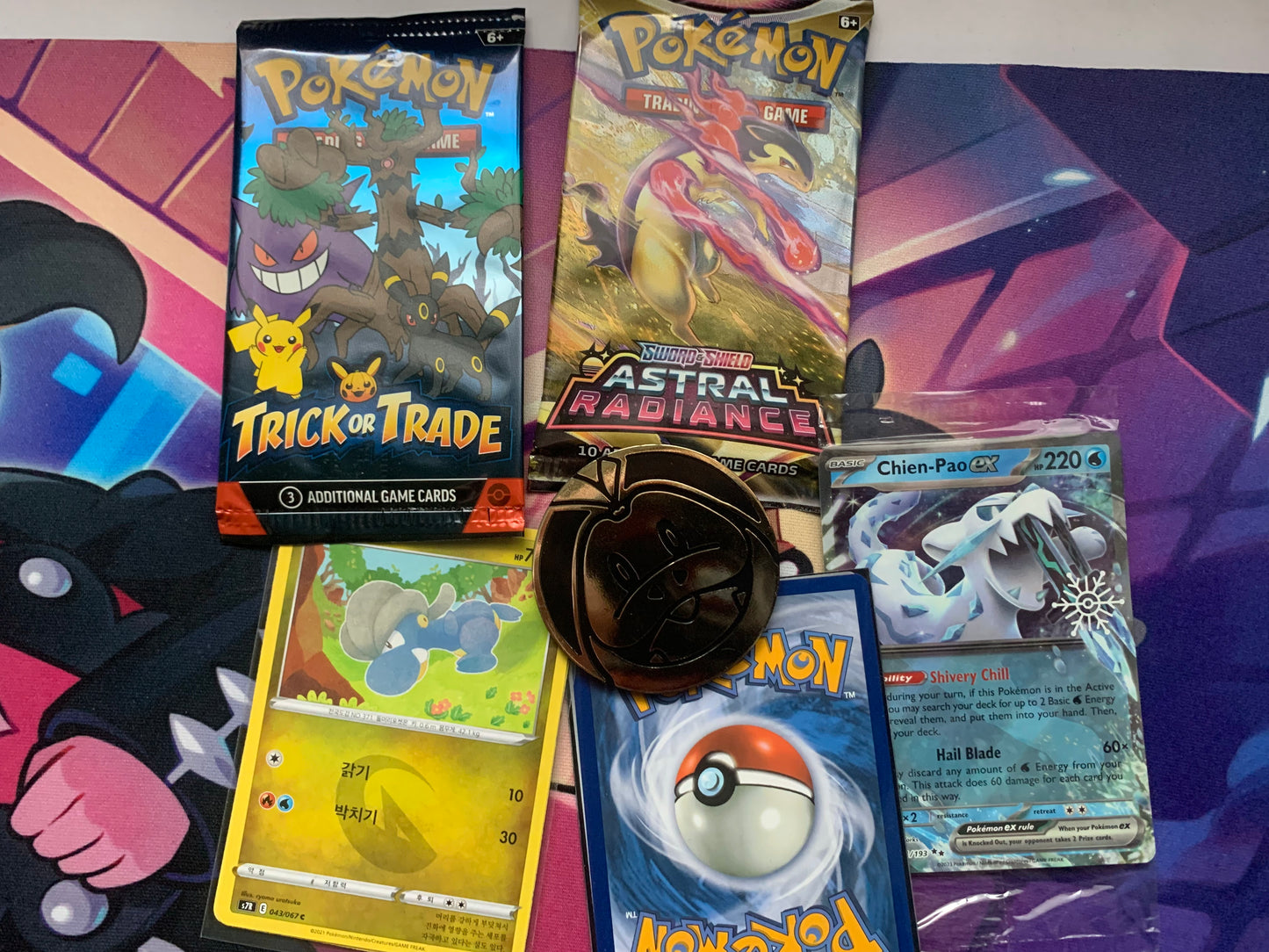 Bundle 4: 2 sealed Pokémon packs, 1 rare/sealed card, 5/4 bonus sleeved Pokémon cards,1 Pokémon coin